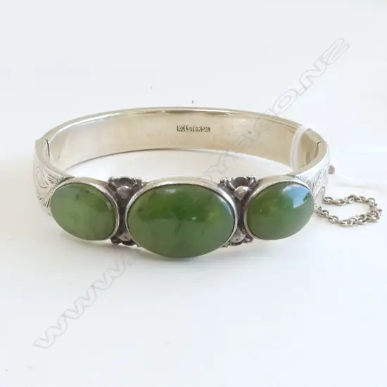 'KCL' SILVER & POUNAMU HINGED BANGLE. Three cabochon panels stylised floral highlights 