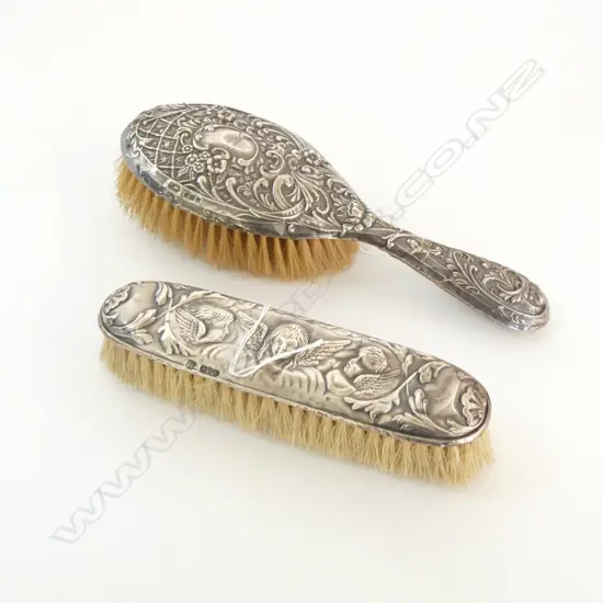 TWO EMBOSSED SILVER BACKED DRESSING TABLE BRUSHES