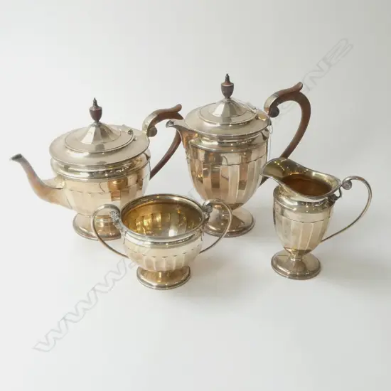 5 PCE SILVER TEA SERVICE includes hot water pot. Fluted body decoration. 1950gms Sheffield 1928