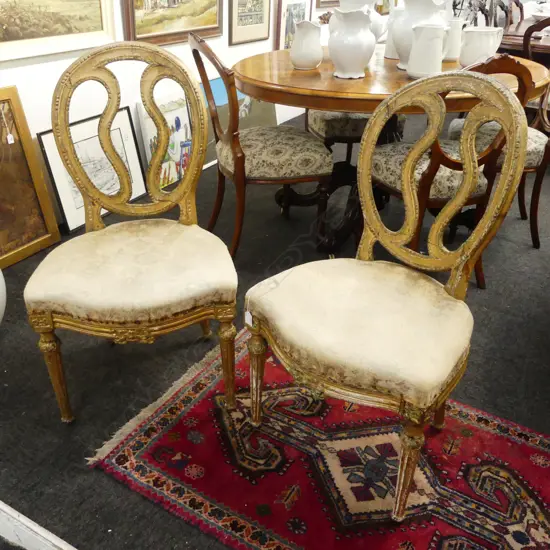 A pair of French late18th/early 19thC Louis XVI gilt salon chairs,