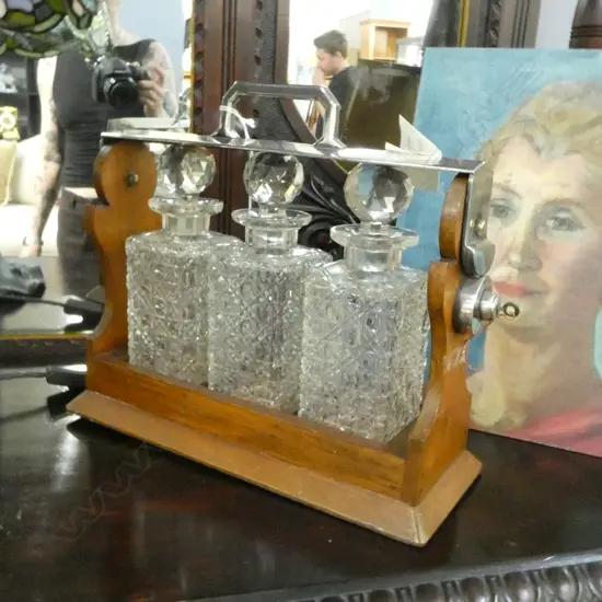 3 CRYSTAL DECANTERS (1 w. rim chip) IN OAK TANTALUS W.370mm