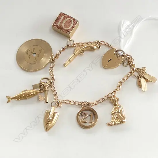 9ct YELLOW GOLD CHARM BRACELET charms incl. record pistol fish key banknote etc heart padlock clasp 16.2gms