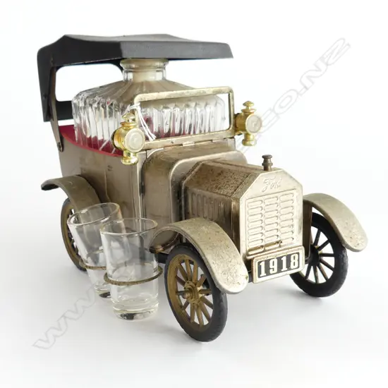 A Ford Motor car with four glasses and decanter inside,