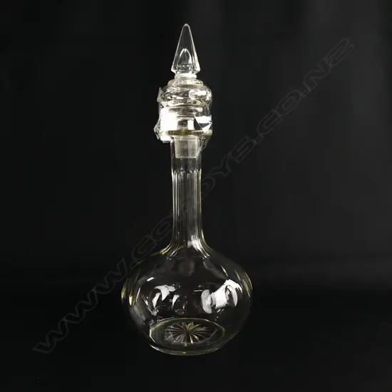 A small glass decanter with pointed top,