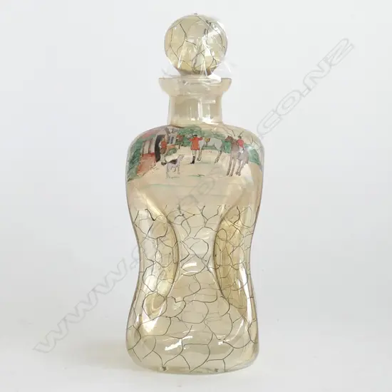 A glass decanter depicting hunting scenes,
