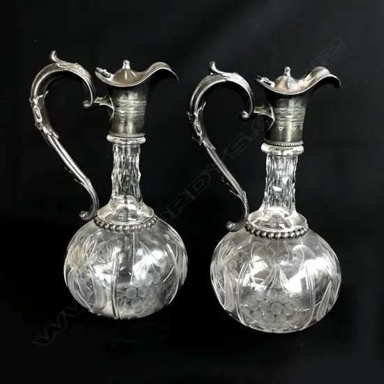 A pair of silver plate  cut and etched crystal duckbill decanters,