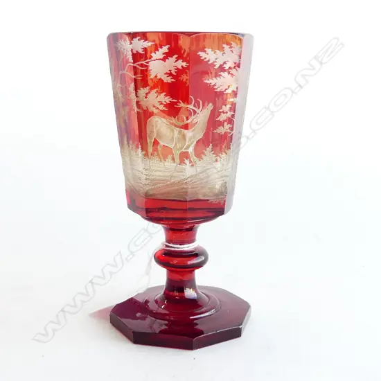 A red glass wine with hunting scene motifs,