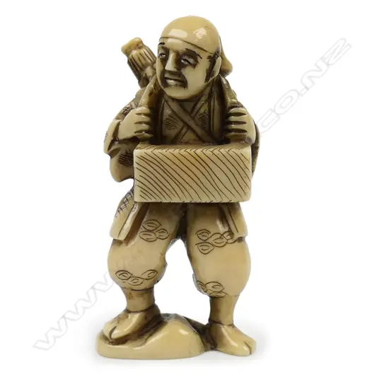 Ivory netsuke of foreigner wearing traditional robes a box hangs around his neck a parasol to his back - signed,