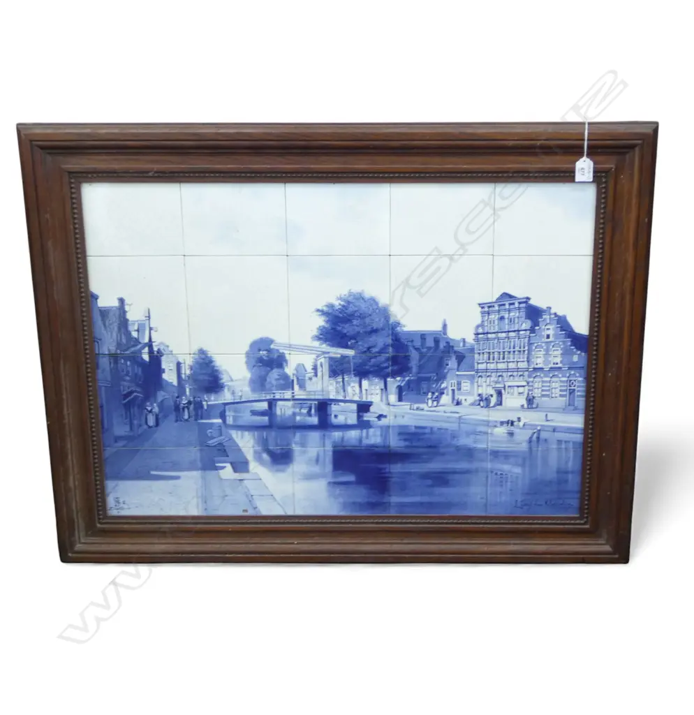 A large Dutch Delft twenty tile picture display painted in underglaze blue forming a canal town scene with figures Image 1++