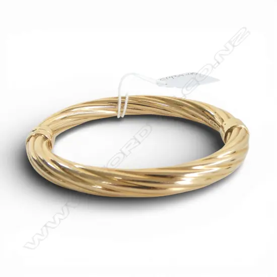 A 9ct gold hinged bangle