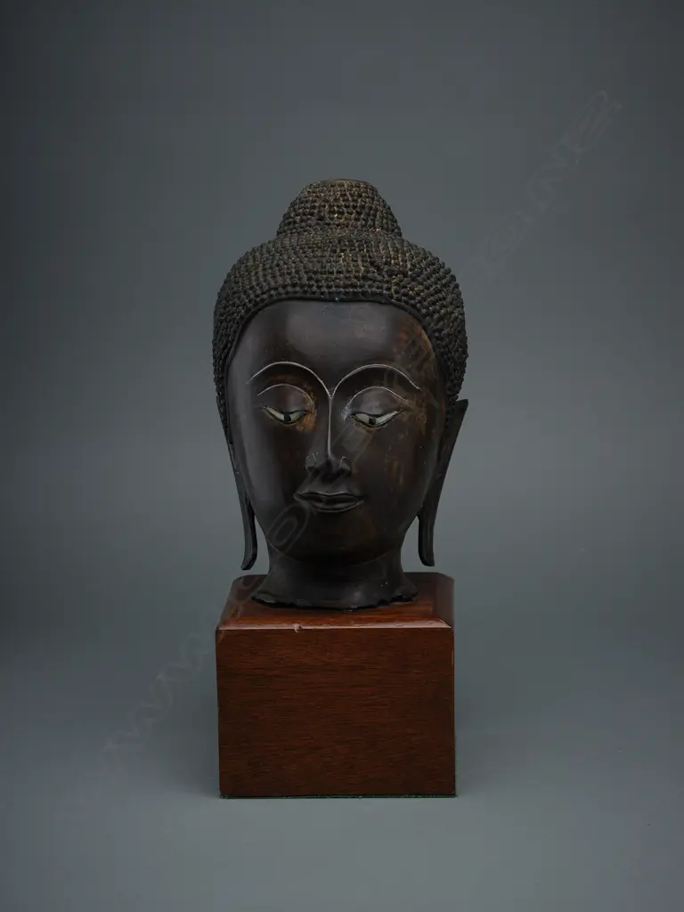 Thai bronze Buddha head fragment, mounted on wooden stand, H.320mm, some traces of gilding Image 1++