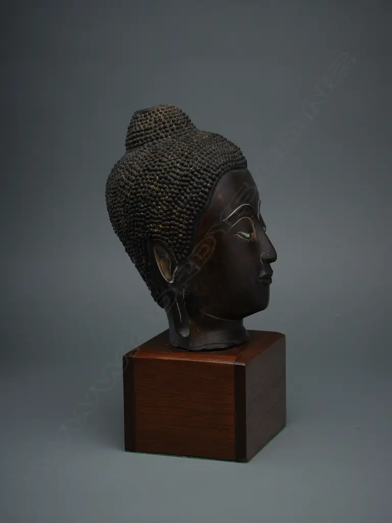 Thai bronze Buddha head fragment, mounted on wooden stand, H.320mm, some traces of gilding Image 1++