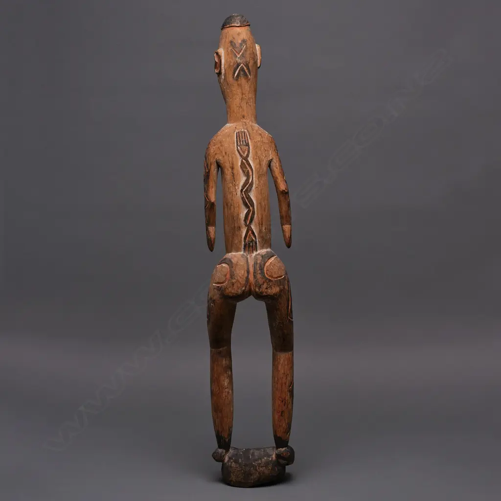 PNG carved wooden standing figure, ochre & black stain, H.760mm Image 1++