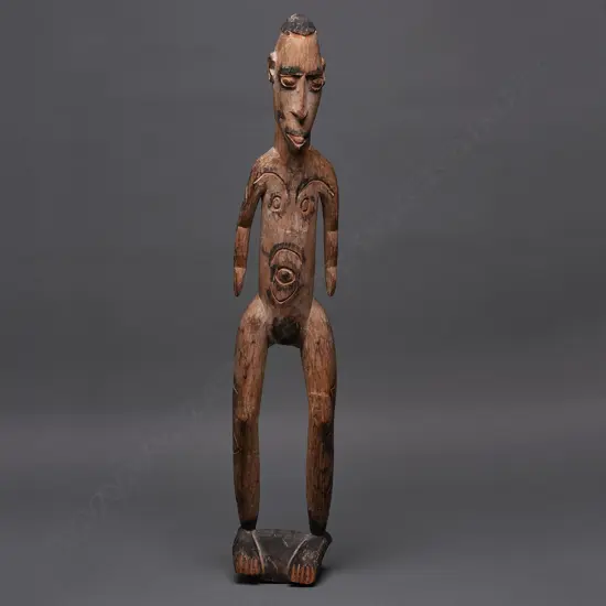 PNG carved wooden standing figure, ochre & black stain, H.760mm