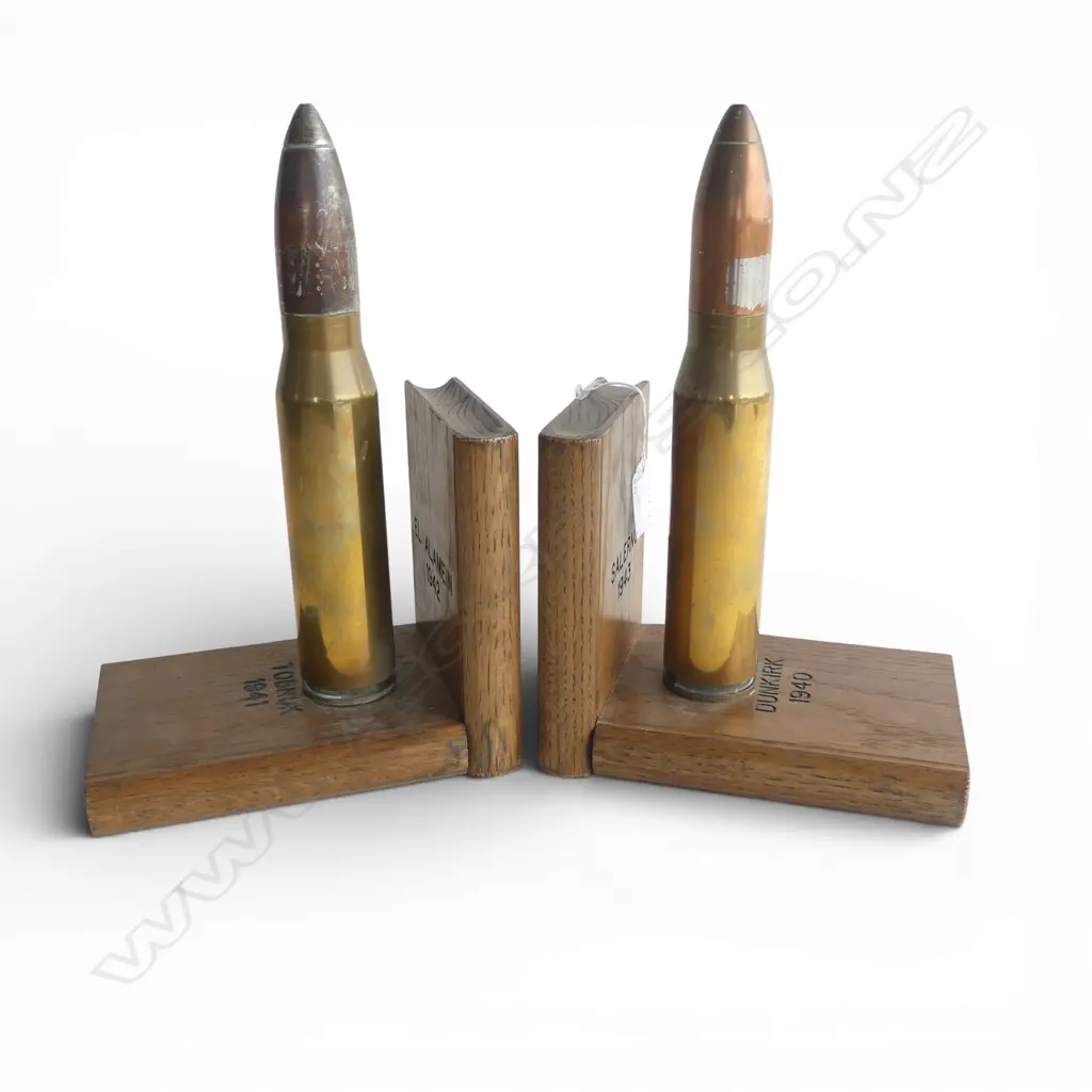 A pair of trench art bookends a shell case set to oak books marked with various WWII battles. H.270mm. Image 1++