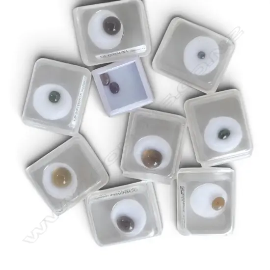 NINE BOXED CABOCHON GEMSTONES From the estate of Simon Misdale.