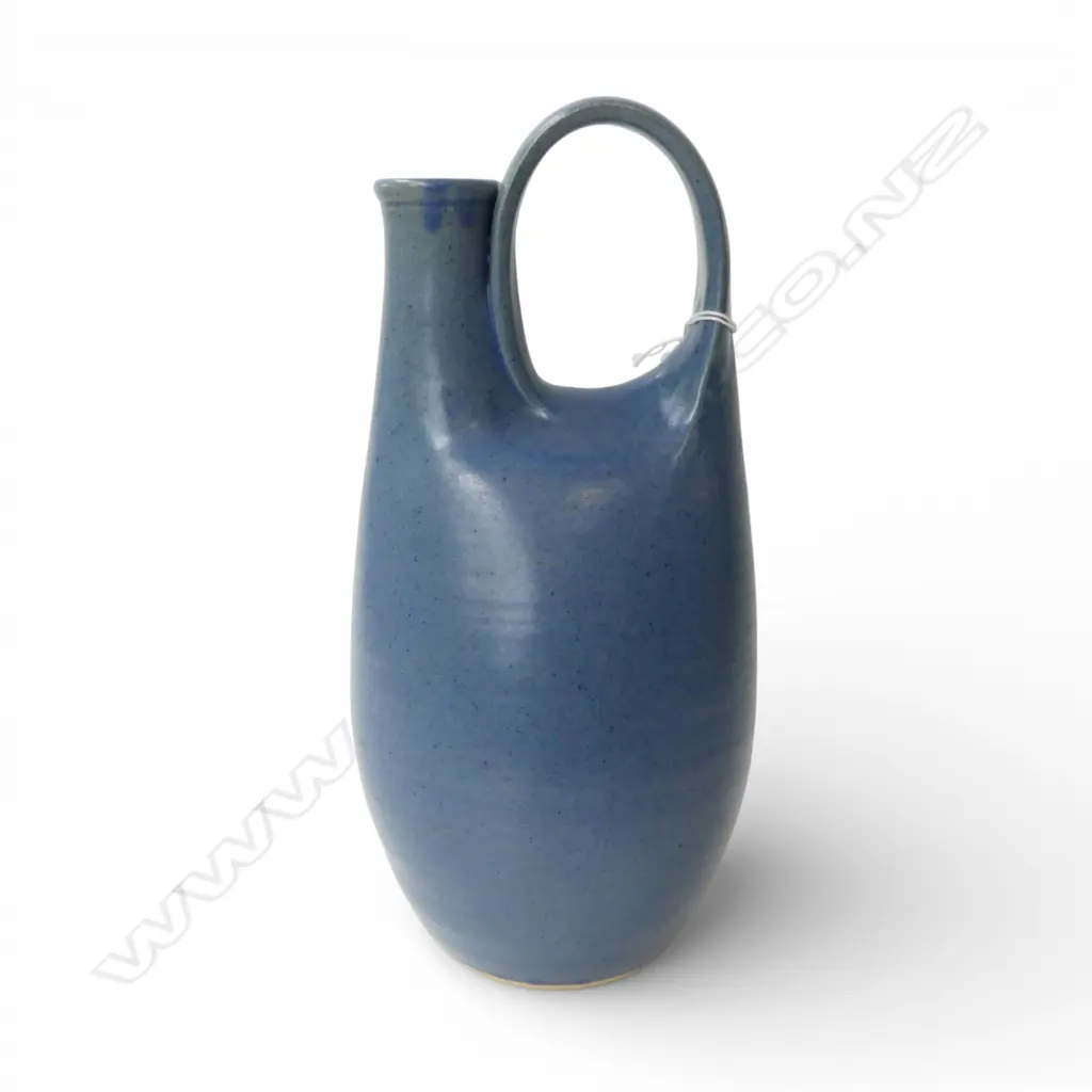 RICHARD CADNESS LOOP HANDLE BLUE GLAZE JUG. Impressed potter's mark. H.300mm Image 1++