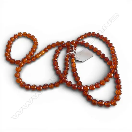 TWO AMBER BEAD NECKLACES From the estate of Simon Misdale