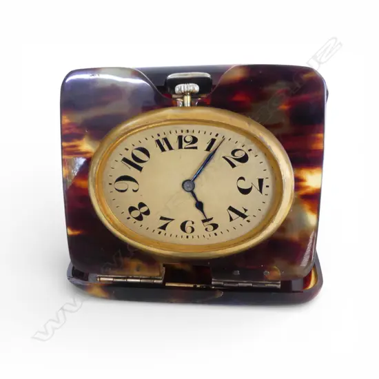 SWISS MADE TRAVELLING CLOCK running. Gilt cased in early tortoiseshell plastic outer case