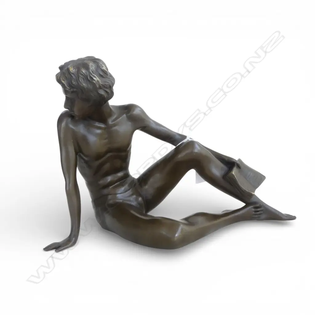 20THc BRONZE YOUNG MAN SEATED with open book. Looking behind over his right shoulder. L.270mm. H.185mm. Image 1++