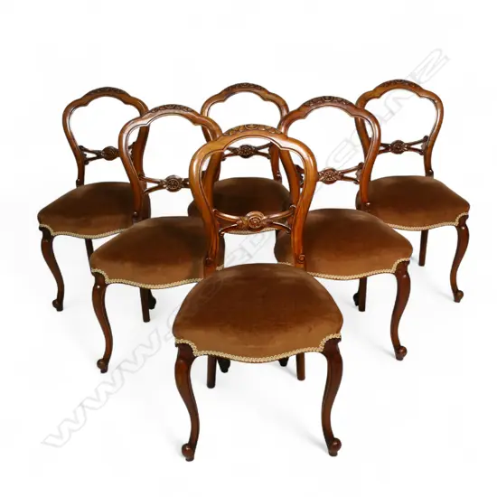 A set of six Victorian walnut carved balloon back dining chairs,