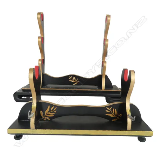TWO JAPANESE BLACK LACQUER SWORD STANDS: ONE FOR THREE SWORDS AND ONE FOR ONE