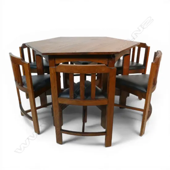 An uncommon Arts & Crafts oak hexagonal table and six shaped chair set,