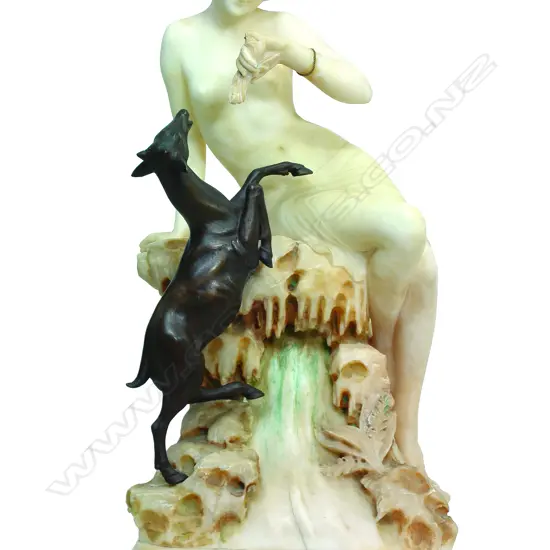 A 1920s Venetian marble sculpture of Diana seated on a rock with a bronze deer reaching up