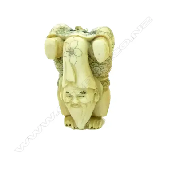 A Japanese carved ivory netsuke on Fukurokuju performing a handstand