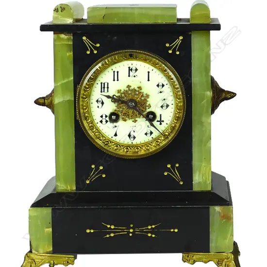 A Victorian black slate and green onyx clock garniture with a pair of five light candelabra