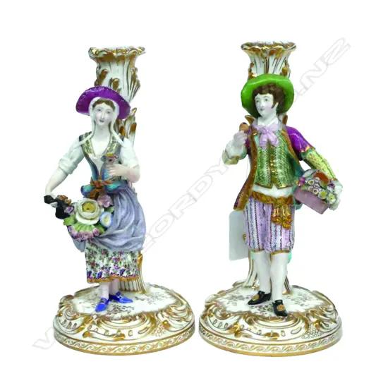 A pair of c.1800 porcelain figured candlesticks
