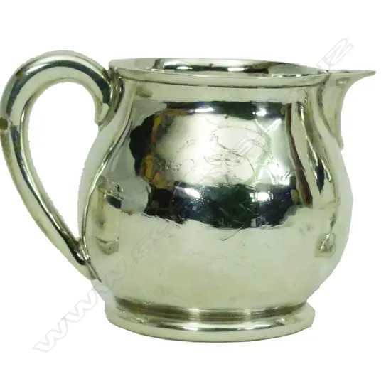 A particularly heavy George II silver milk jug
