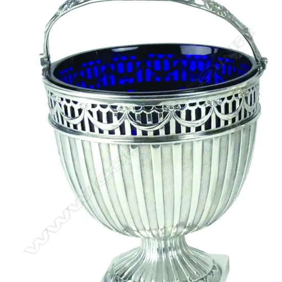 A Victorian silver swing handled sugar basket with original Bristol Blue glass liner