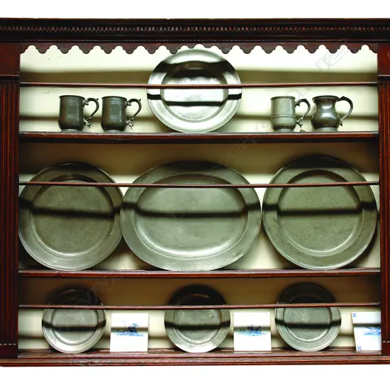 A Geo. III wall mounting pewter plate rack