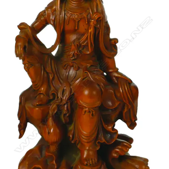 A carved boxwood statuette of Kuanyin