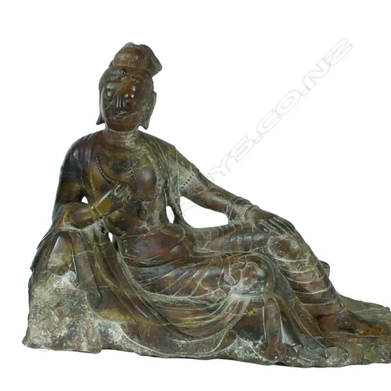 A Chinese carved mottled red stone Kuanyin statuette
