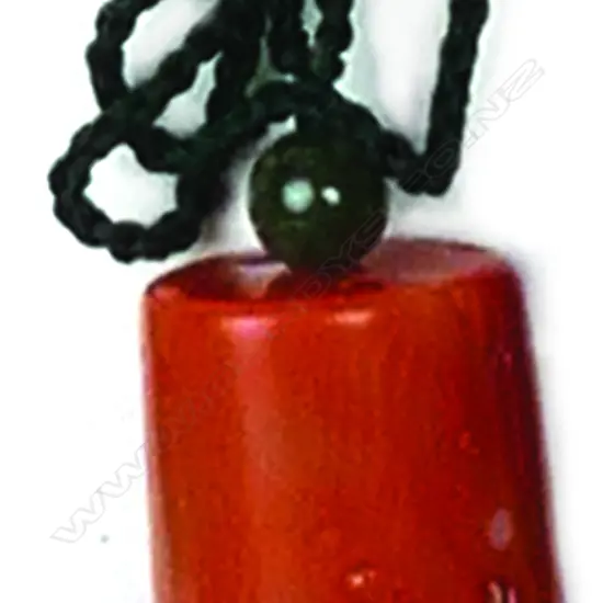 A large cylindrical orange coral bead