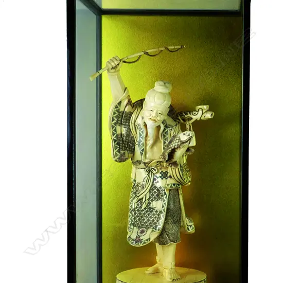 A large Japanese sectional bone carving of a fisherman
