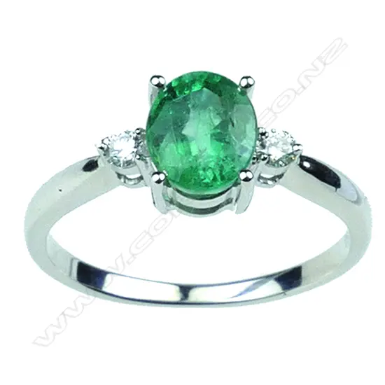 An 18ct. white gold modern emerald and diamond ladies ring
