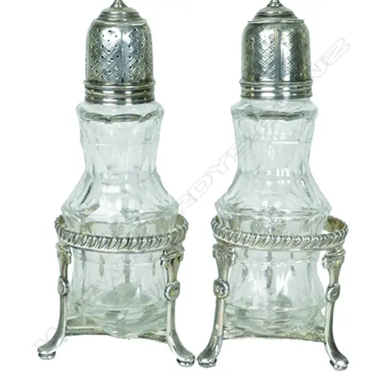 A pair of cruet bottles with silver tops