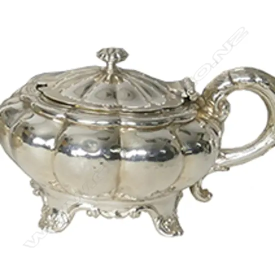 A William IV silver mustard pot of melon shape on shell and scroll feet