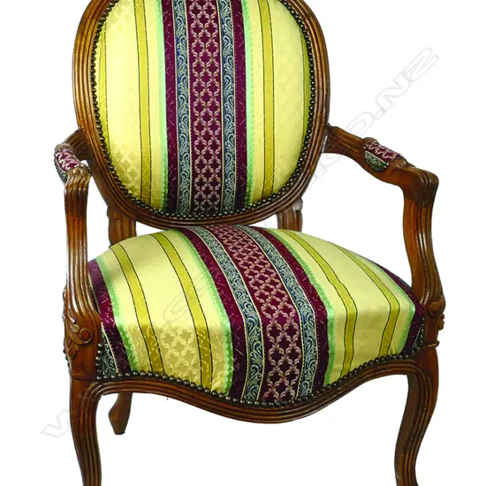 A pair of French walnut open elbow chairs of Louis XV style