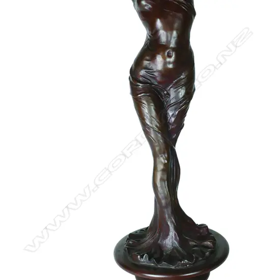 A bronze statue of a woman in the art Nouveau manner
