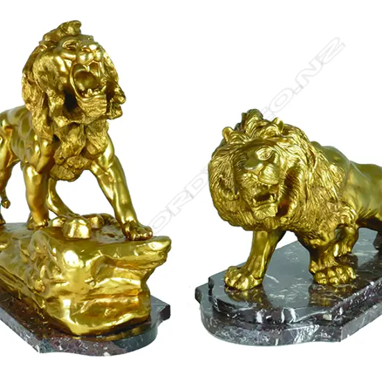 A pair of gilt bronze lions in the manner of Antoine-Louis Barye