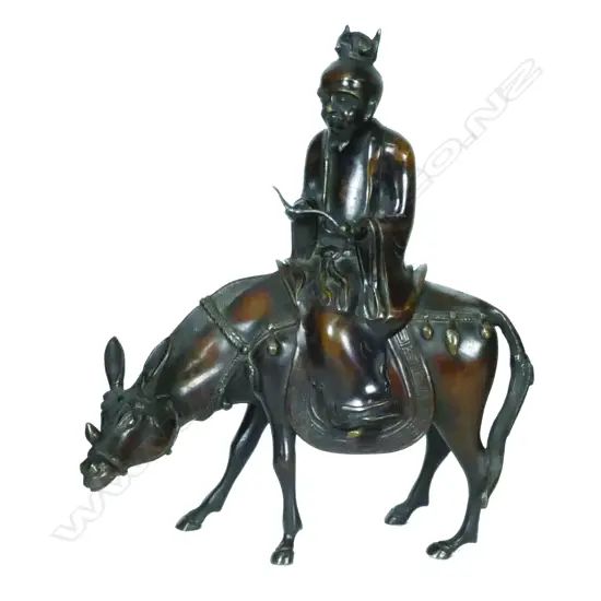 An Oriental bronze statuette of the immortal Zhang Guo-lao riding a mule