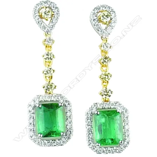 An elegant pair of 18ct yellow and white gold emerald and diamond earrings