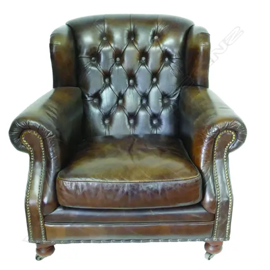 A pair of dark brown leather club chairs