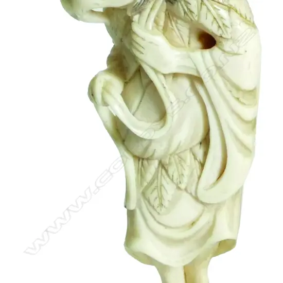 An old Japanese carved ivory netsuke of an old farmer