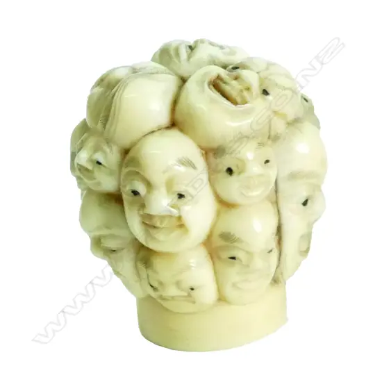 A Japanese Meiji period multi-face carved ivory cane handle