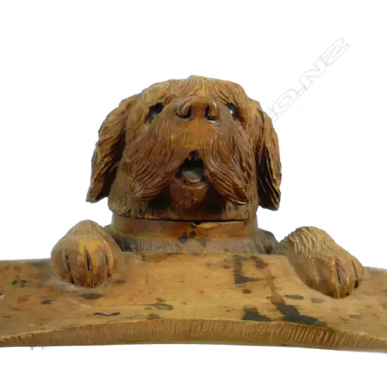 An antique 'Black Forest' carved fruitwood inkwell modelled as a dog